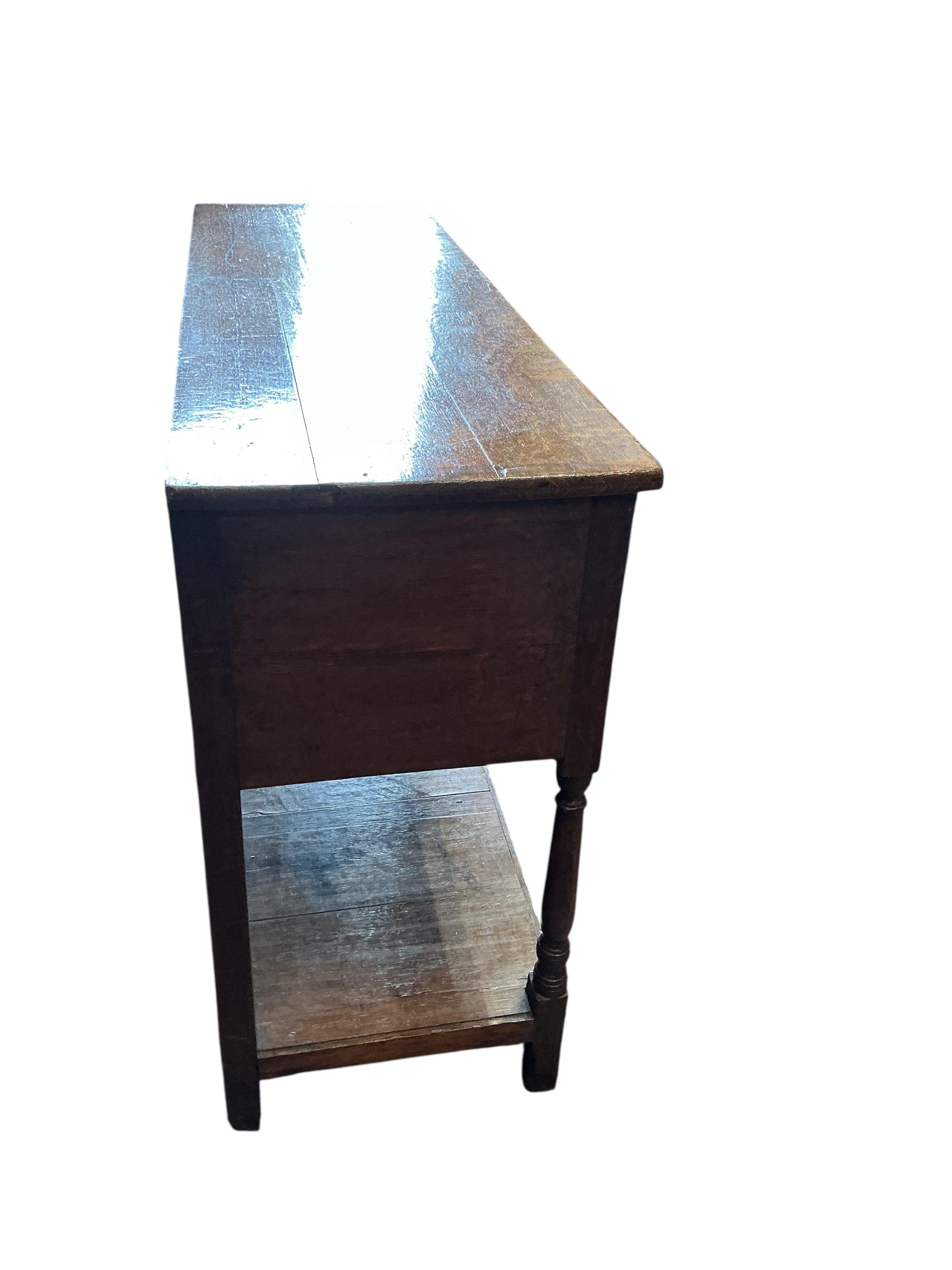 A small George III oak low pot board dresser, width 125cm, depth 39cm, height 79cm